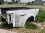 2020 F350 platinum color is pearl white has a ding in the passenger Dooley flare. And the driver bed rail is dented from a fifth wheel. - Image 3