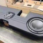 a custom car audio system package that includes: - Amp - Sub box - 2 JL Audio 13.5 TW5’s - Plug and play harness for a HK system - 4 gauge OFC and RCAs - JL Audio 1000/1D - Driver’s side back wall plate